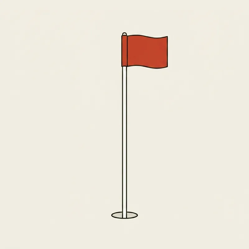 A flagstick standing upright in a hole with a red pennant at the top