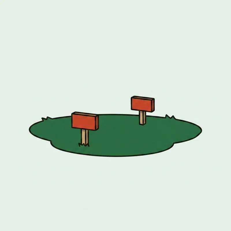 A pair of golf tee markers set on a mown teeing ground