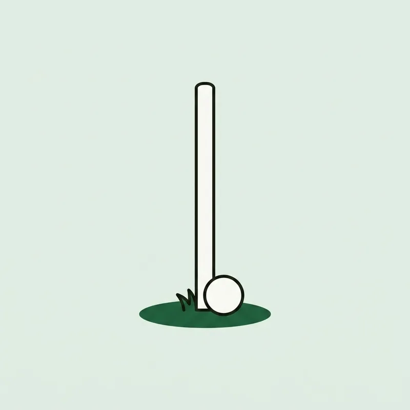 A single white boundary stake in the ground with a golf ball resting on the grass beside it