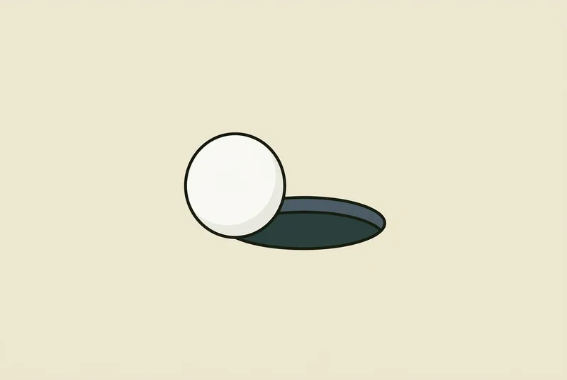A single golf ball resting against the near edge of a golf hole
