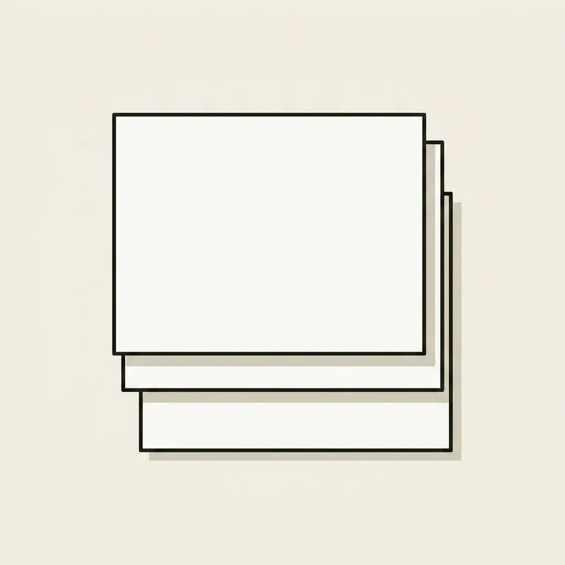 Three plain unprinted paper cards lying flat in a stack, each offset slightly from the one below