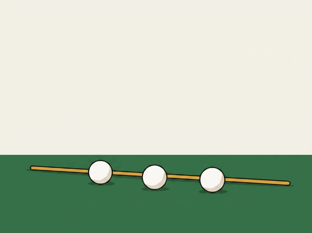 Three golf balls in a row on short grass beside a single alignment stick lying flat on the ground