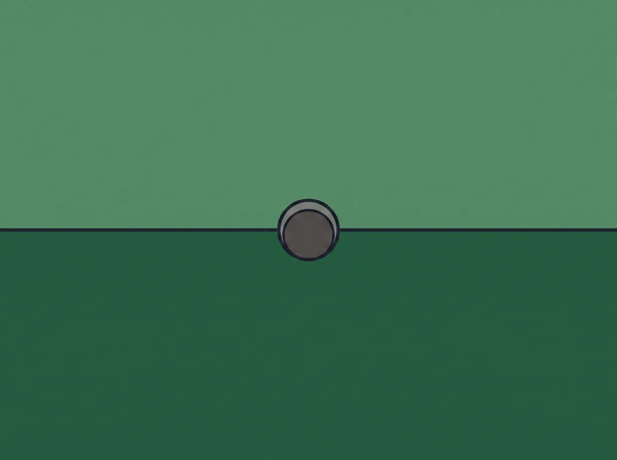 A putting green surface seen from above split into a lighter upper band and a darker lower band with a hole between them
