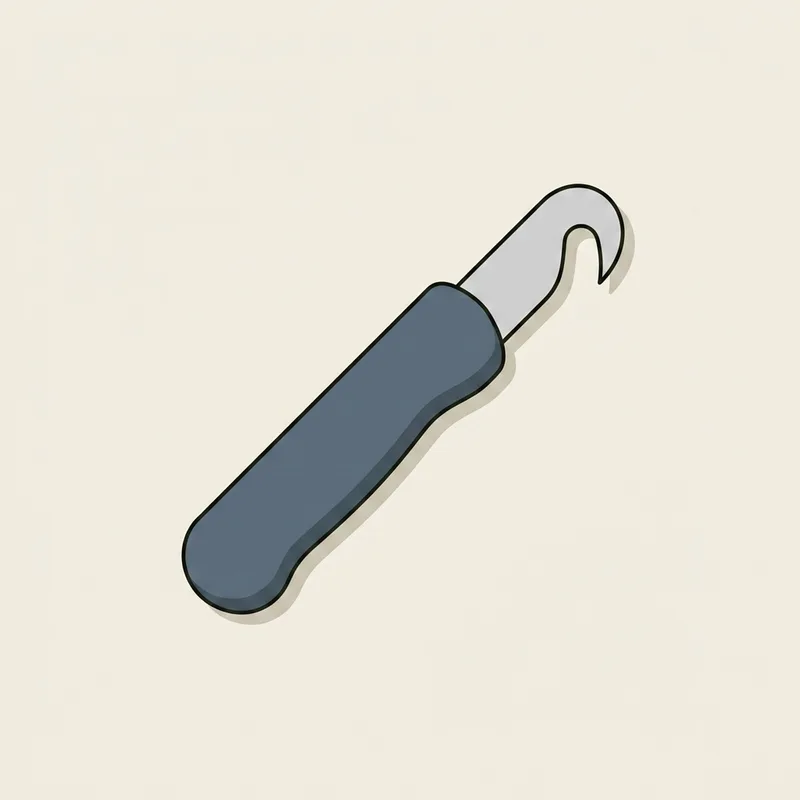 A utility knife with a short curved hook blade lying flat on a surface