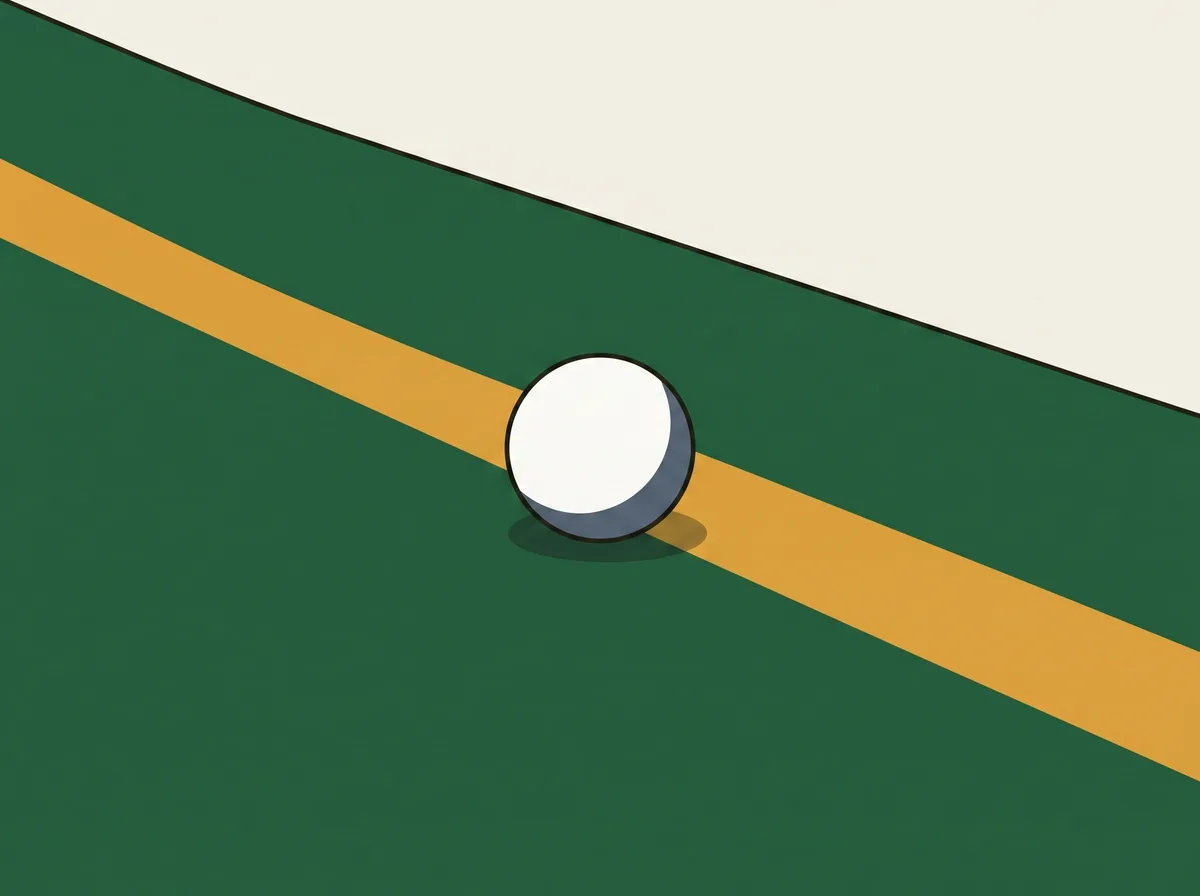 A golf ball resting on short grass immediately beside a straight painted boundary line on the ground